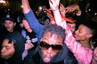 a group of people with their hands up in the air