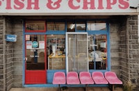 a building with a sign for fish and chips