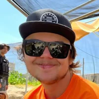 a young man wearing sunglasses and a hat