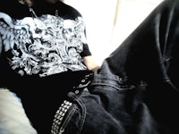 a man wearing a black t - shirt and jeans