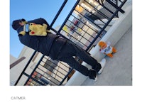 a man with a teddy bear on a railing