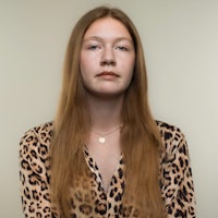 a young woman in a leopard print shirt