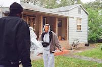 a group of people standing in front of a house