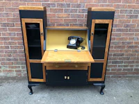 a black and wood desk with a telephone on it