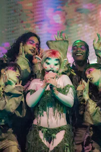 a group of people dressed in green costumes posing for a photo