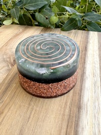 a spiral shaped stone on top of a wooden table