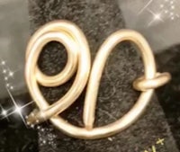 a gold ring with the letter o on it