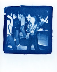 a photo of a group of people in blue polaroid