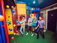 a group of people playing in a children's play area
