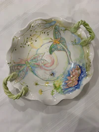 a plate with a dragonfly design on it