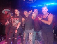 a group of people posing for a picture on stage