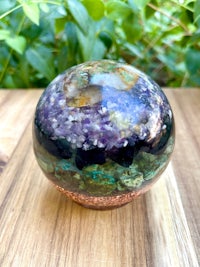 an amethyst crystal ball on a wooden table
