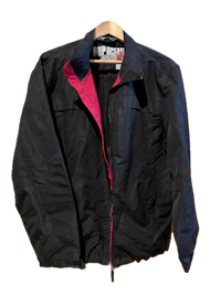 a black and pink jacket hanging on a hanger