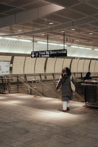 a woman walking in a subway station