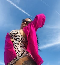 a woman in a pink leopard print bikini posing for a photo