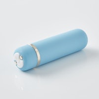 a blue cylinder on a white surface