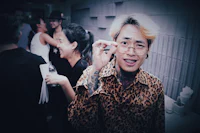 a man wearing a leopard print shirt and glasses
