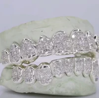 a pair of white diamond grills on a white background
