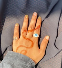 a woman's hand with a snake painted on it