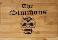 a wooden cutting board with a sugar skull on it