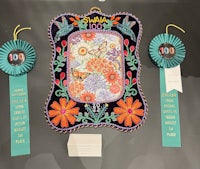 a frame with ribbons and ribbons on it