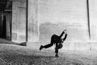 a black and white photo of a person doing a handstand
