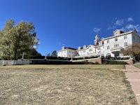 a large white house on a grassy field