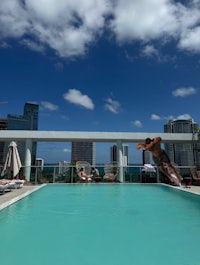 a man jumps into a pool at a hotel in miami