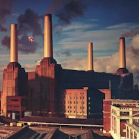 a large building with smoke coming out of the chimneys