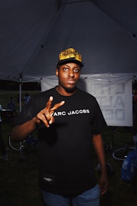a man is posing for a picture under a tent