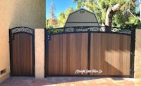 a wooden gate with wrought iron accents
