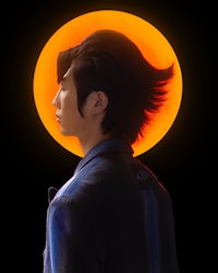 an asian man in front of a sun