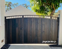 a wooden gate in front of a house