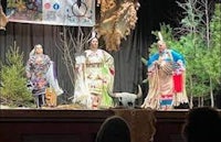 a group of people dressed in native costumes on stage