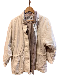a white jacket hanging on a hanger