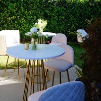 a white table and chairs in a garden