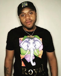 a man wearing a black t - shirt with an elephant on it