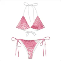 a pink and white bikini set with roses on it
