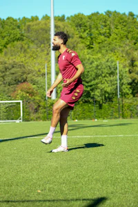 a man kicking a frisbee on a soccer field