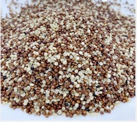 a pile of quinoa seeds on a white plate