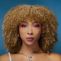 a woman with a curly afro posing on a blue background