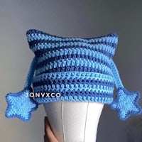 a blue and white crocheted hat with stars on it