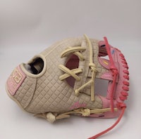 a pink and beige baseball glove on a white surface