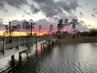 a bridge over a body of water at sunset