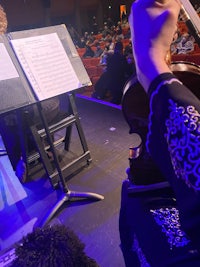 a person playing a violin in front of an audience