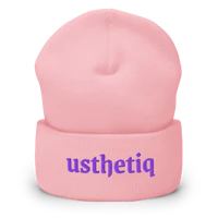 a pink beanie with the word pithesu on it