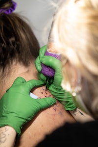 a woman getting a tattoo