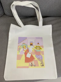 a white tote bag with an image of a little girl