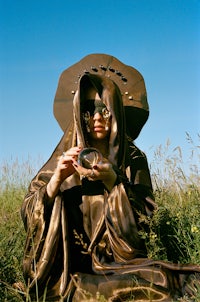 a woman in a robe holding a camera