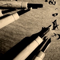 a black and white photo of a group of writing utensils